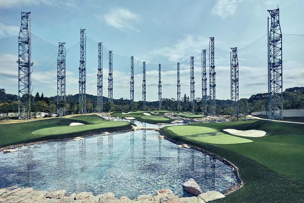 Charlotte Synthetic grass golf course with water and tall metal towers